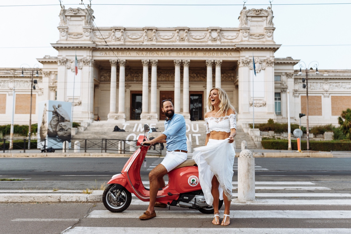 romantic holiday in Italy. Couple on vespa in Rome.