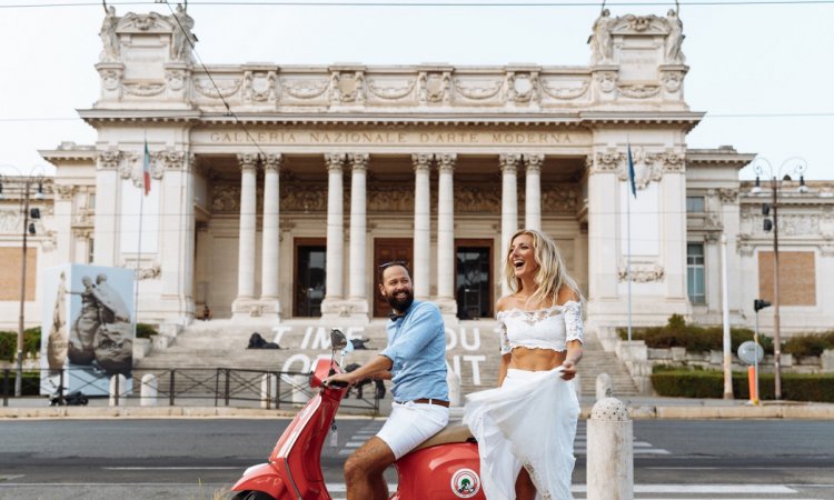 A couple on a scooter in front of the Galleria Nazionale in Rome.